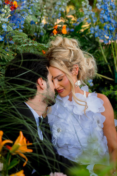 bride and groom surrounded by flowers