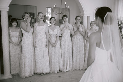 Black and white photo of bride with her bridesmaids before the ceremony