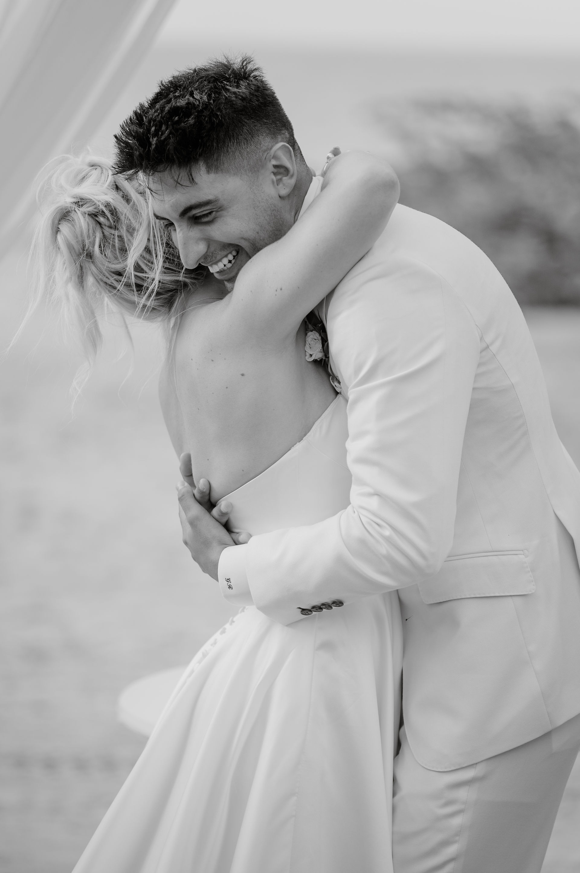 bride and groom hugging