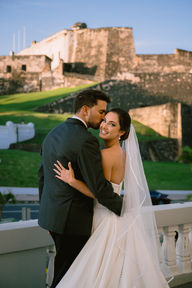 Groom kissing bride on the cheek during portraits