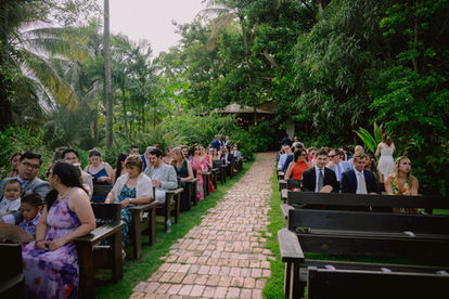 Outdoor ceremony setup with guests seated facing the aisle at Hacienda Siesta Alegre