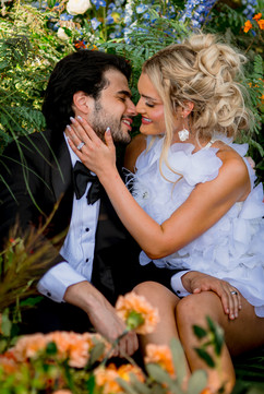 bride and groom surrounded by flowers