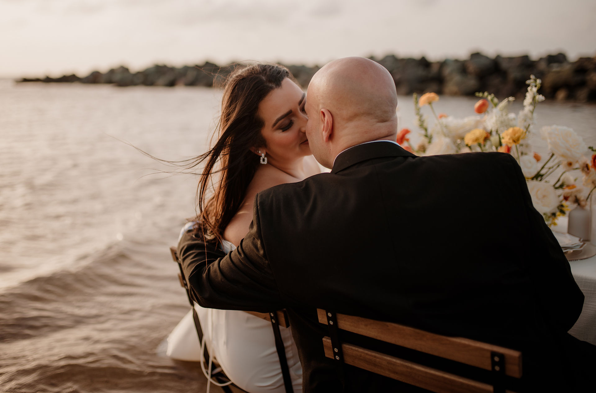 Romantic anniversary session with soft waves and a golden sunset