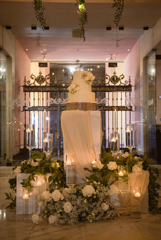 Three-tier white wedding cake with floral details at Hotel El Convento reception