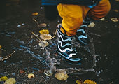 Child jumping in puddles symbolising joy, play and resilience – 2b Inclusive Adelaide allied health and Behaviour support