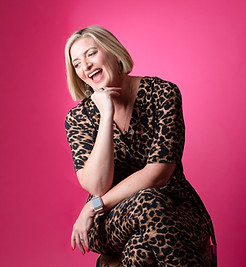 Portrait of Camilla Young against a pink background
