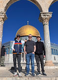 3 men standing on the steps in front of the Dome of the Rock