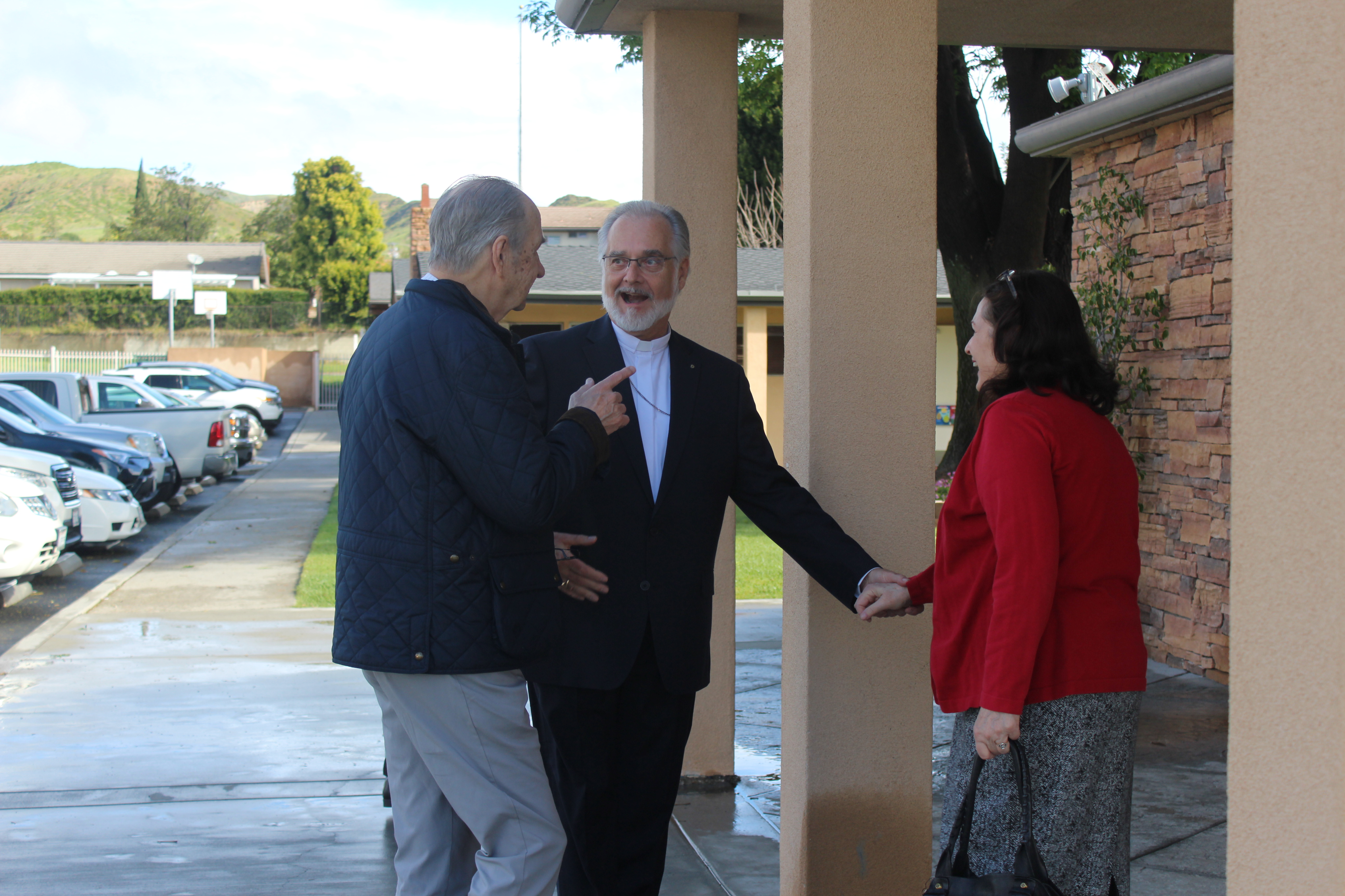 Pastor greeting congregation members