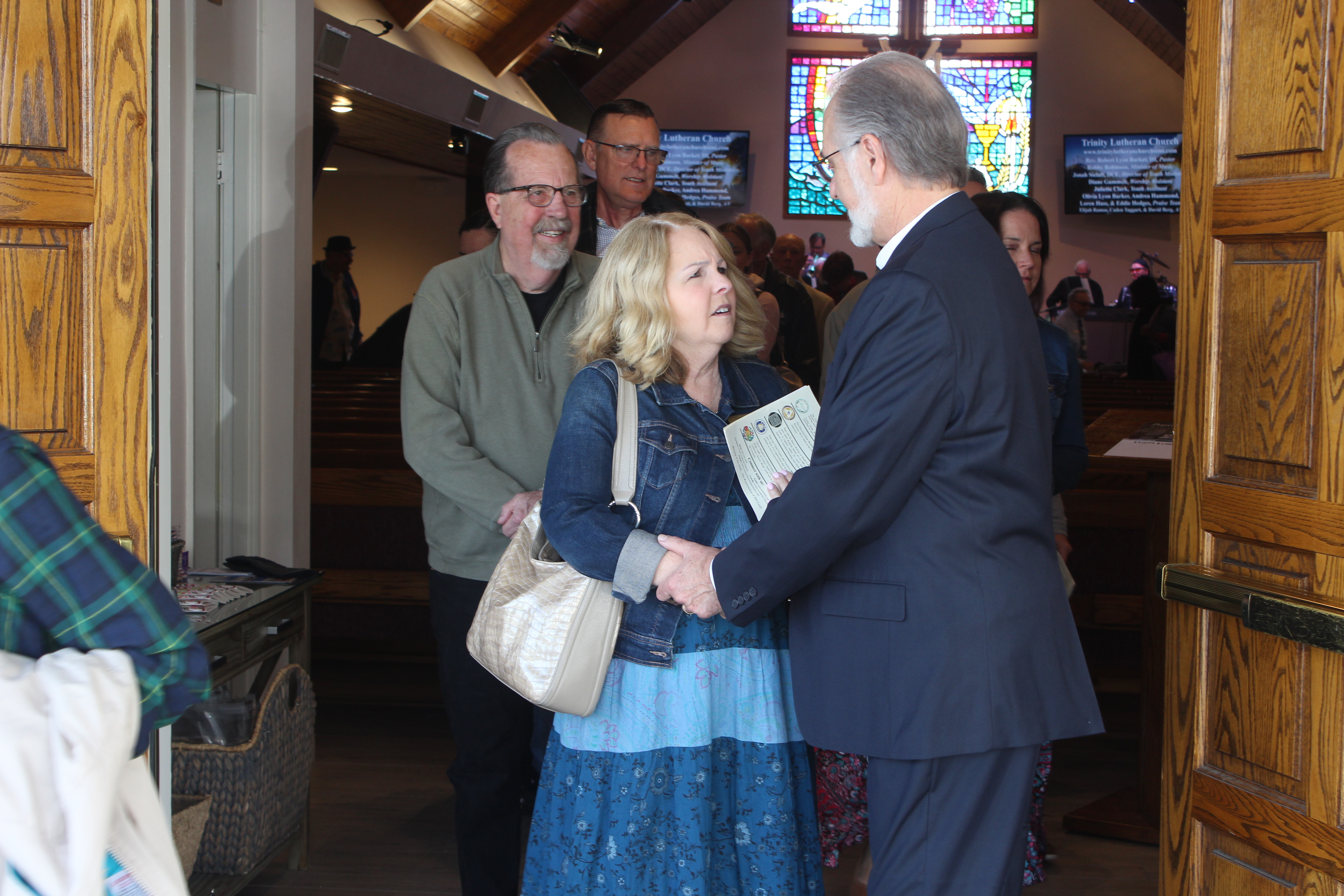 Pastor talking to congregation members