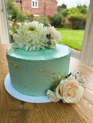 elegant turquise cake with fresh flowers