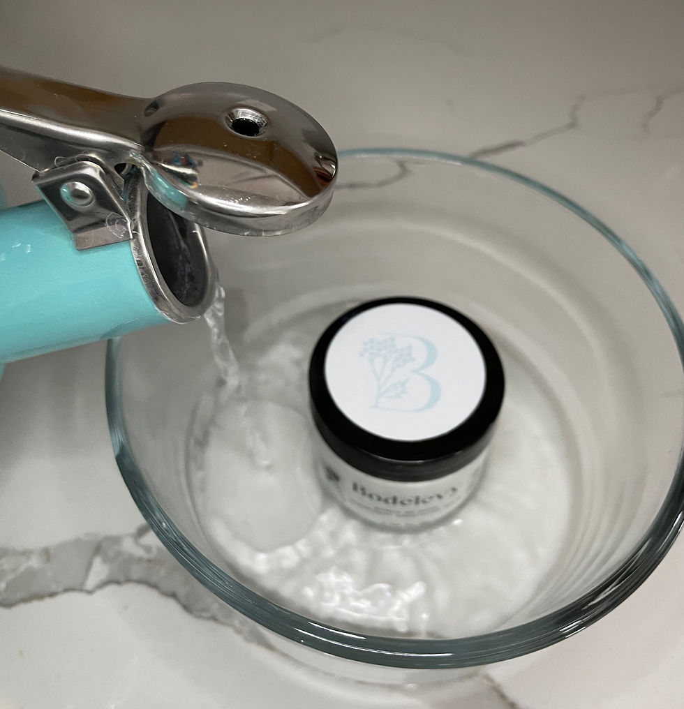 water pouring from kettle into bowl with jar in it