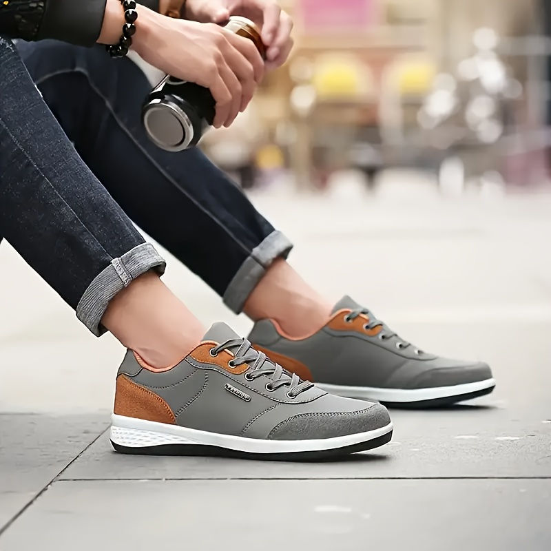 Thumbnail: Person wearing waterproof leather walking sneakers outdoors