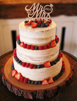 Semi-naked dairy-free wedding cake with fresh fruit