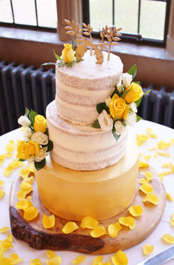 Gold tier semi-naked wedding cake