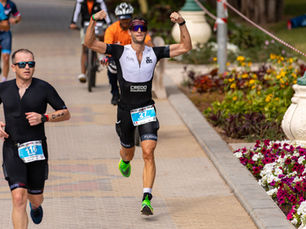 Triathlete running during a race – endurance training and race nutrition concept