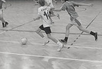 Kids playing indoor soccer