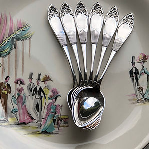 A Silver Set Of Tea Spoons Or Dessert Spoons With A Bow Design.