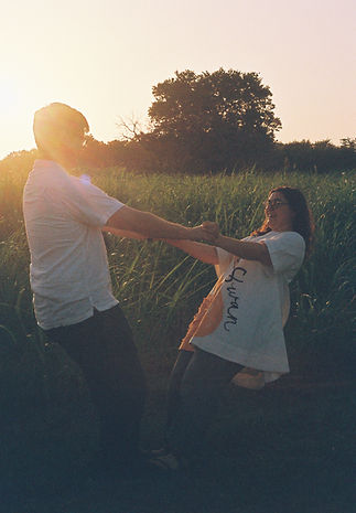 couple in a field holding hands