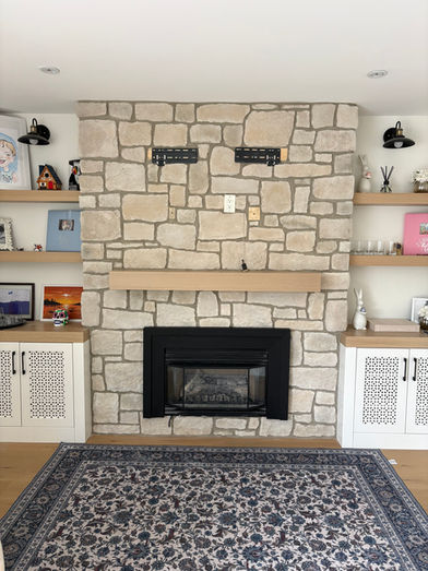 Custom indoor fireplace installation featuring Casa Blanca RoughCut manufactured stone by Eldorado Stone in Whitby, Ontario