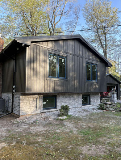 Professional exterior manufactured stone veneer masonry work using Canyon Stone Cathedral Grey Ashlar in Milton