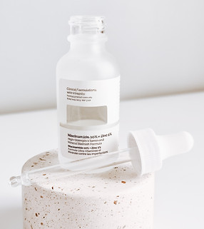 white plastic bottle on white table_edited.jpg