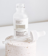 white plastic bottle on white table_edit
