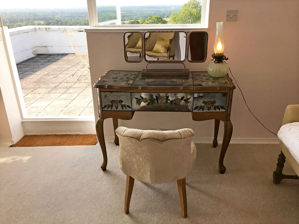 Joldwynds is a 1930s art deco iconic house by Oliver Hill. Pioneering British modernist architecture. Grade II listed building near London available for exclusive hire | weekends | staycation | weddings | film location | photo shoot | workshops | corporate team building | retreats | music video location | escapes. Detail of top floor dressing table  with terrace & views to the valley. Photo by Philippa Heimann