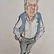 Caricatura em estilo desenho com aquarela de Paulo Rocha de corpo inteiro. Ele aparece sorrindo, de cabelos grisalhos penteados para trás, vestindo camisa social branca de mangas compridas dobradas, colete azul aberto, suspensórios e calça social cinza com as mãos nos bolsos. No rodapé, a assinatura do cartunista Paixão.