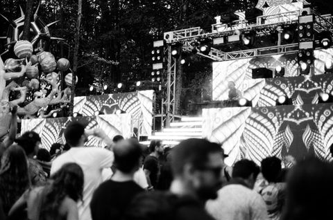 black and white photo of a music festival stage taken from the crowd's point of view