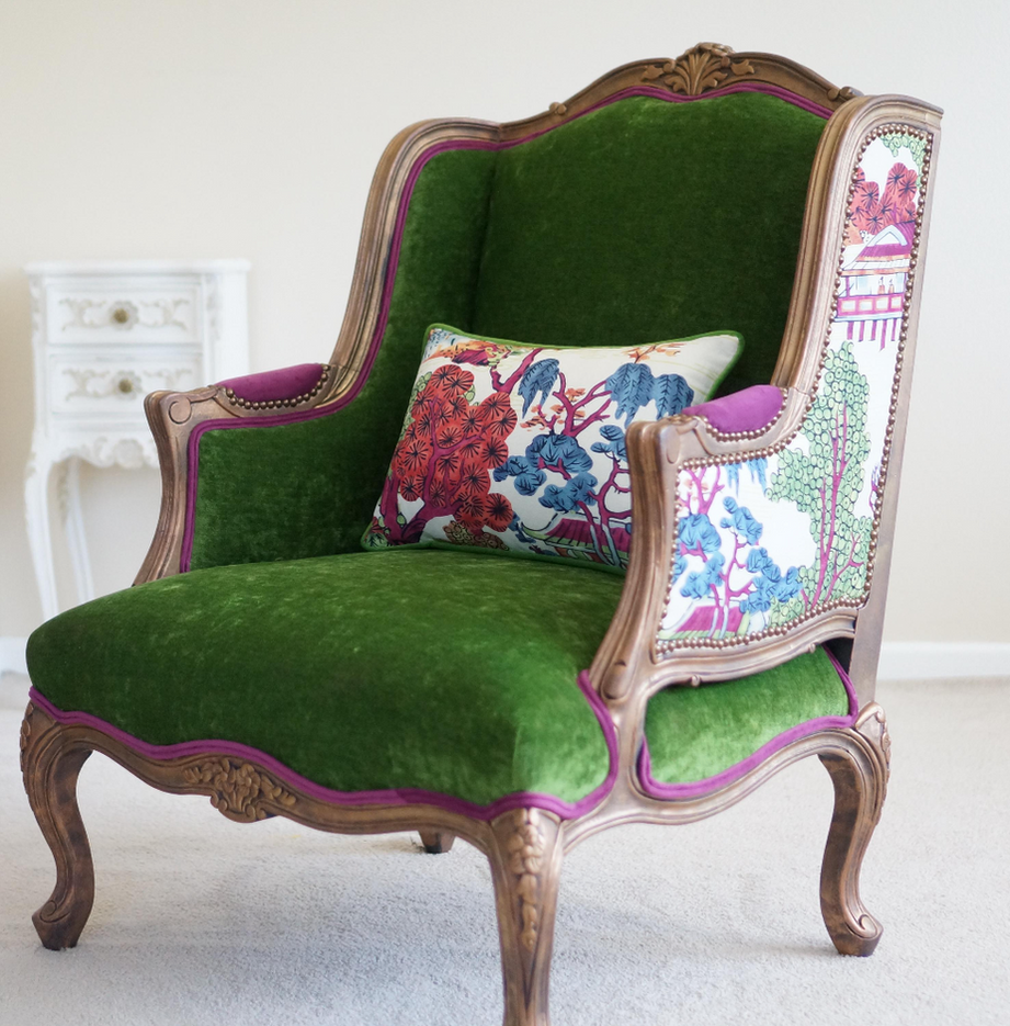 Elegant Chinoiserie French Bergere chair. Thibaut print back, green velvet seat, fuchsia trim, and antique copper gilding.
