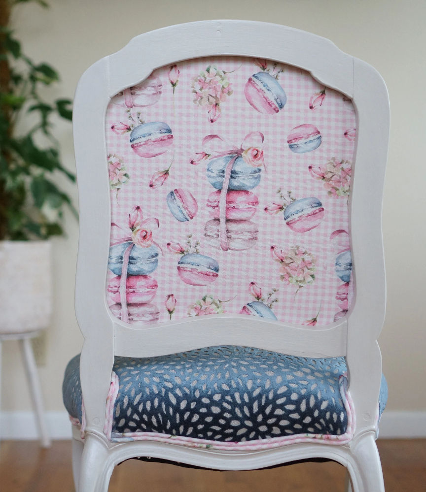 French side chair with a pearlescent white frame, pink checkered back, and a blue textured velvet seat.