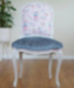 French side chair with a pearlescent white frame, pink checkered back, and a blue textured velvet seat.