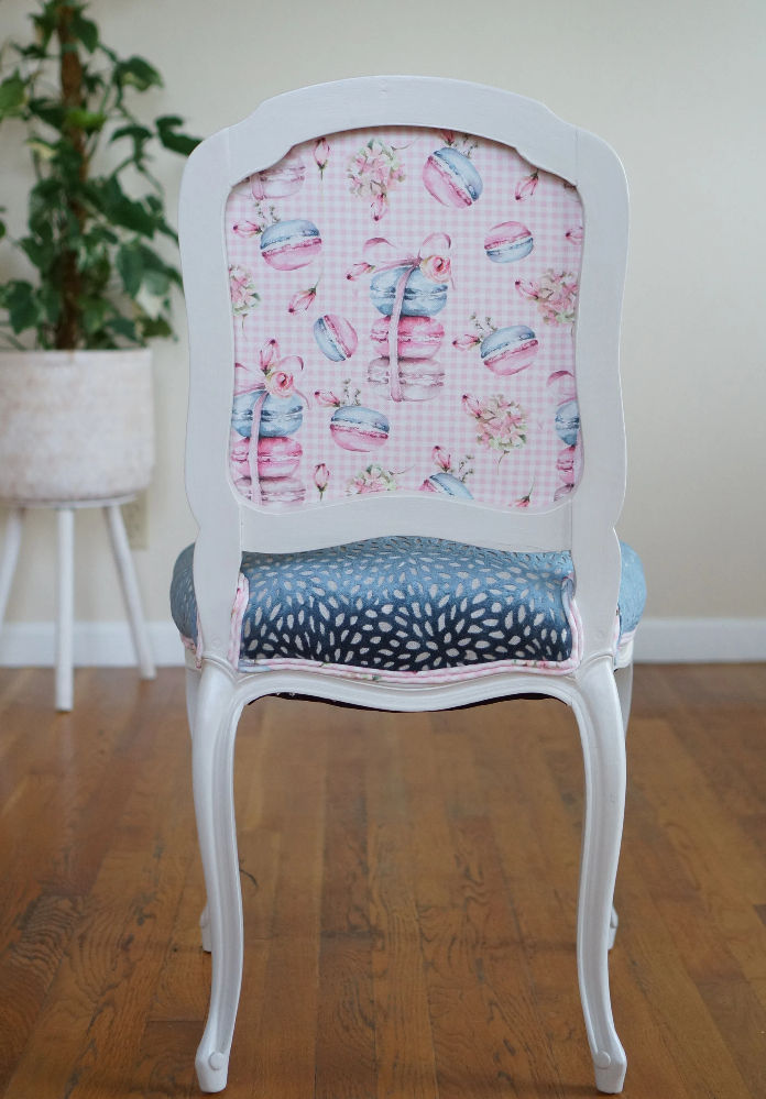 French side chair with a pearlescent white frame, pink checkered back, and a blue textured velvet seat.