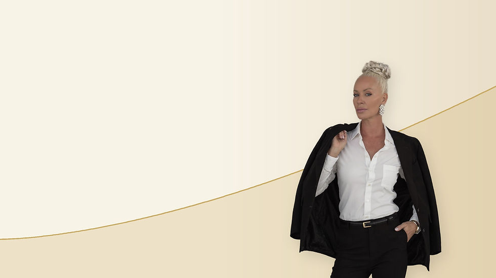 Updated hero portrait of Audrey in a white shirt and black jacket on a cream and gold wave background