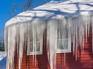 A large ice dam forming on the gutter of a home