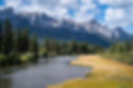 beautiful-shot-river-through-village-surrounded-by-hills-mountains-greenery-websize.jpg