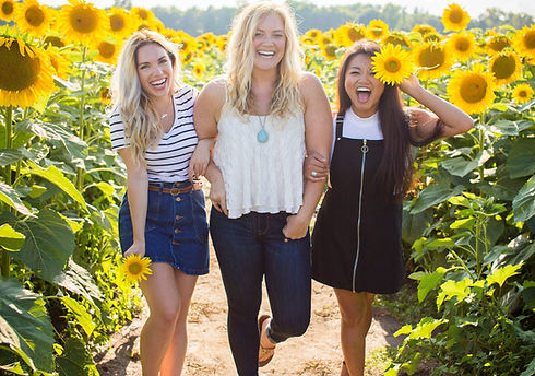 three%20women%20standing%20between%20sunflowers_edited.jpg