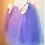 Thumbnail: side view of 2 lavender tulle skirts hanging on a hook