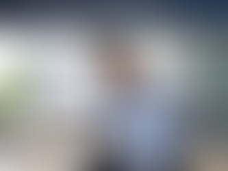 Office worker holding neck in pain at desk with computer screen showing forward head posture