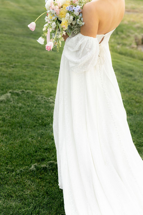 bride walks away with bridal bouquet