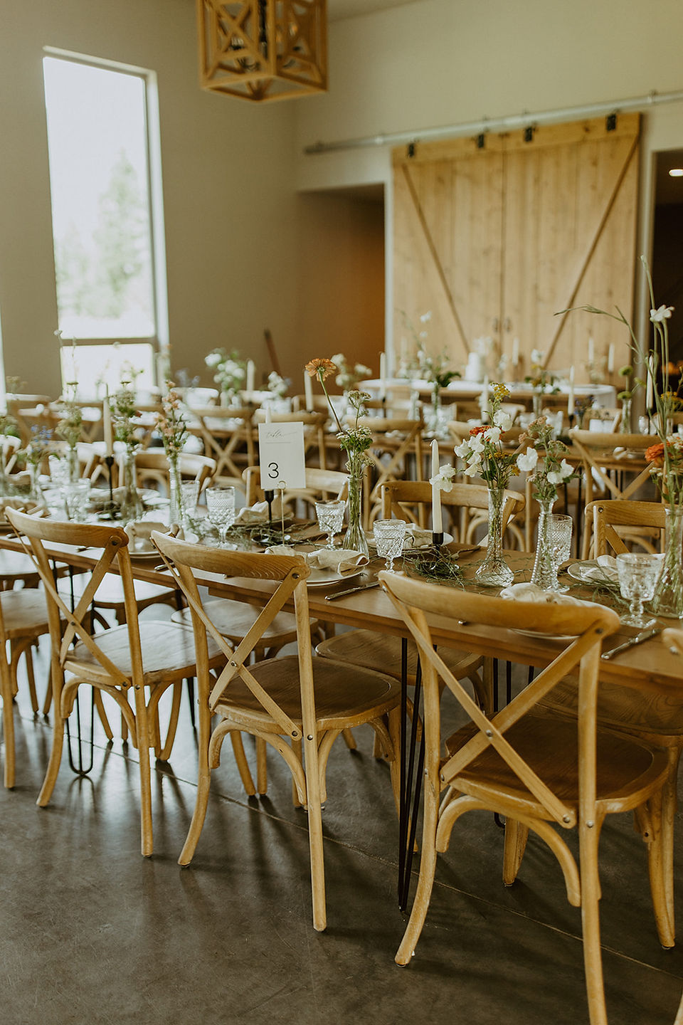 wooden table and chairs with wildflowers