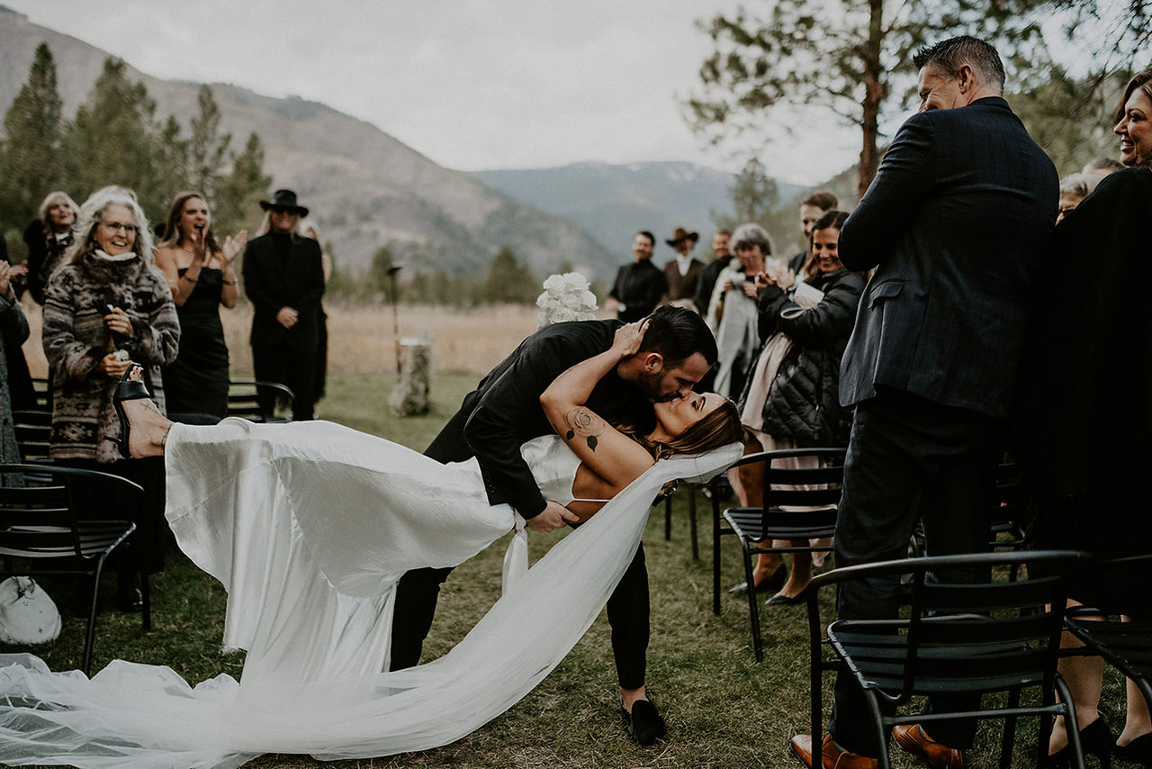 bride and groom dip in the middle of aisle