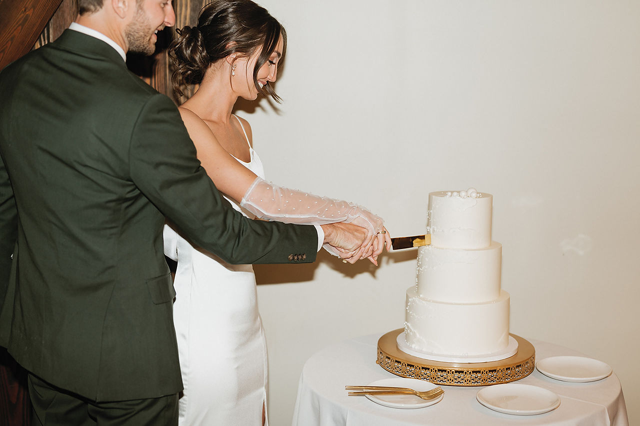 bride and groom cut their wedding cake