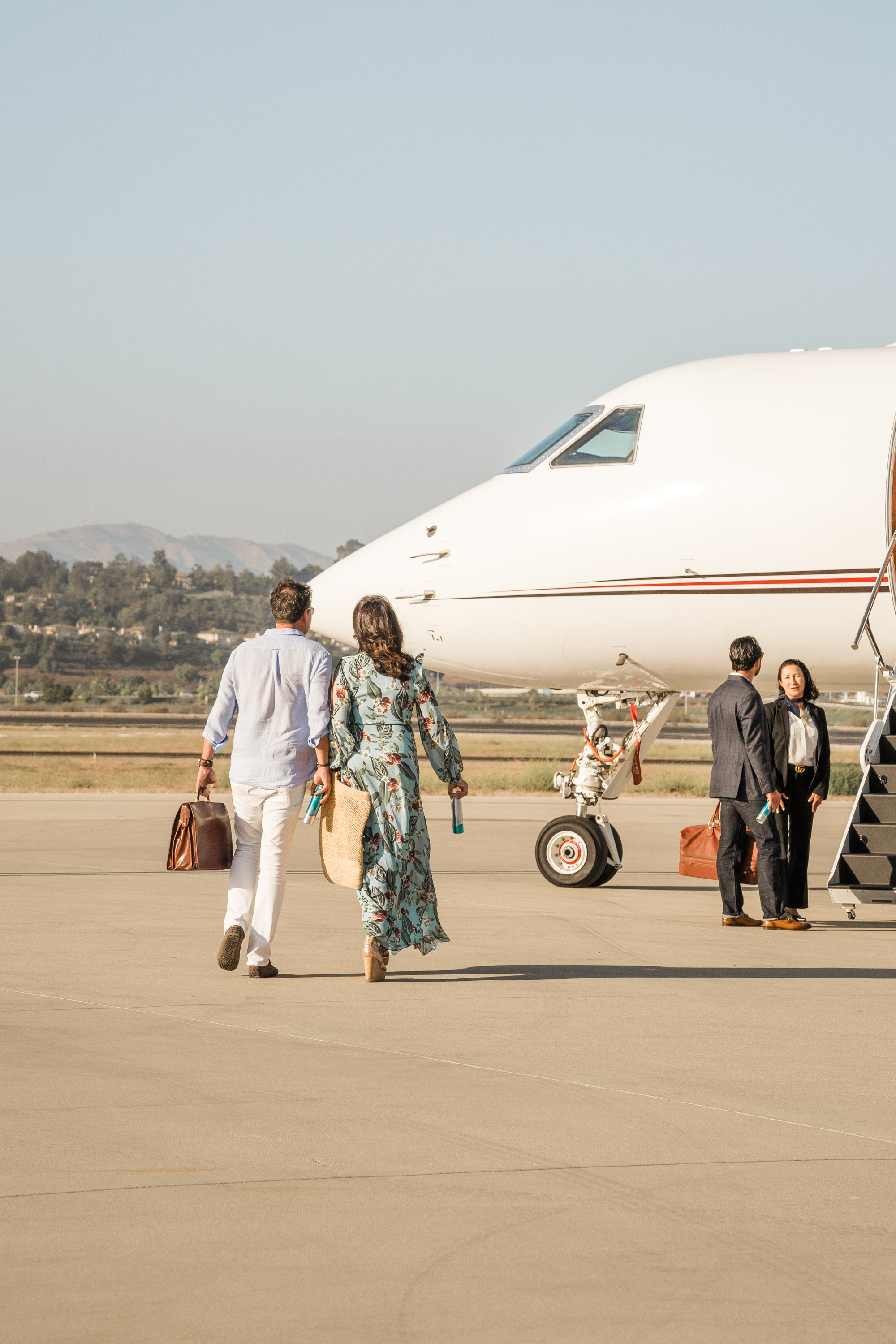 Couple walking towards a private jet