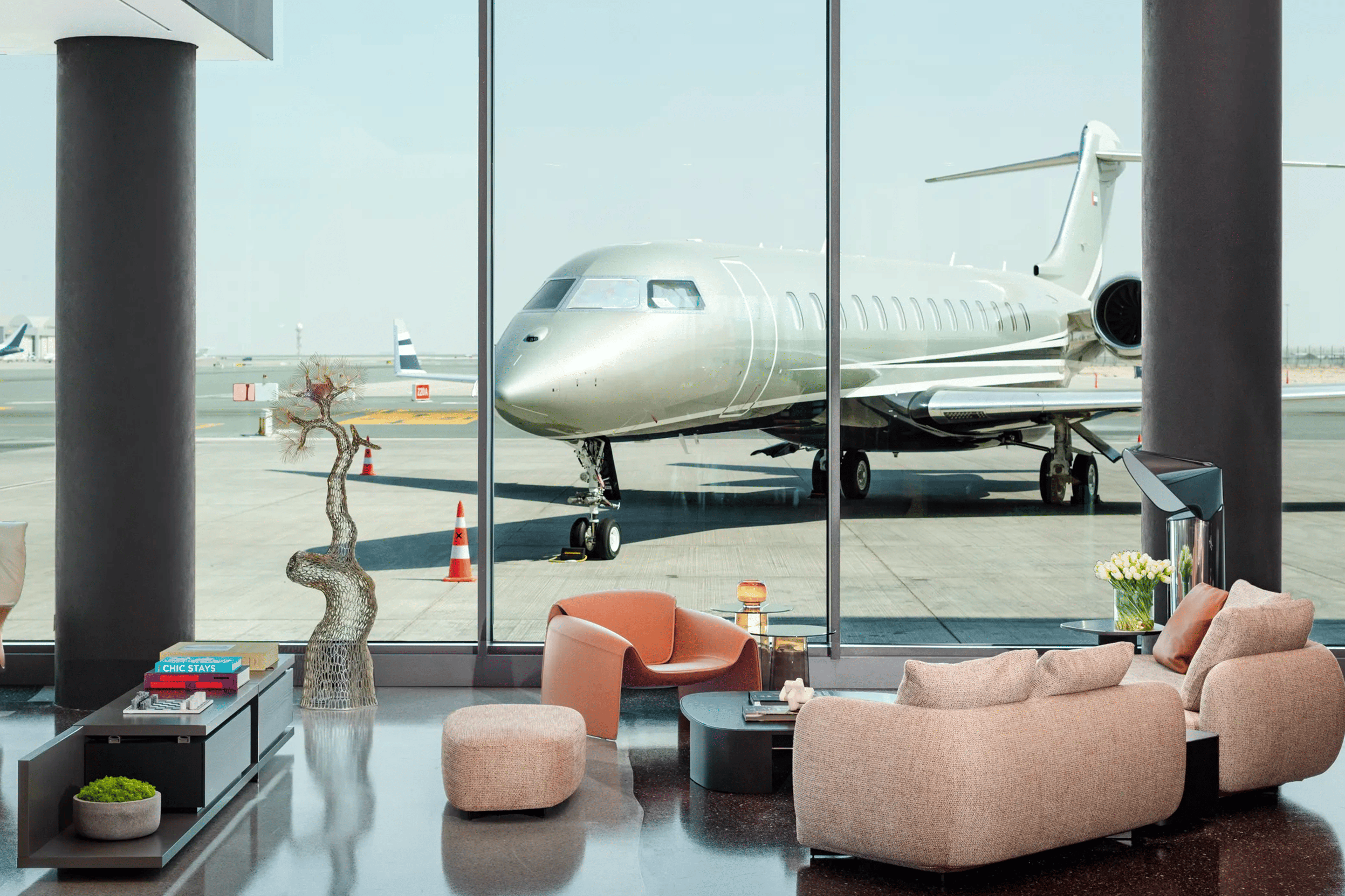 Exclusive airport lounge with a private jet in the background