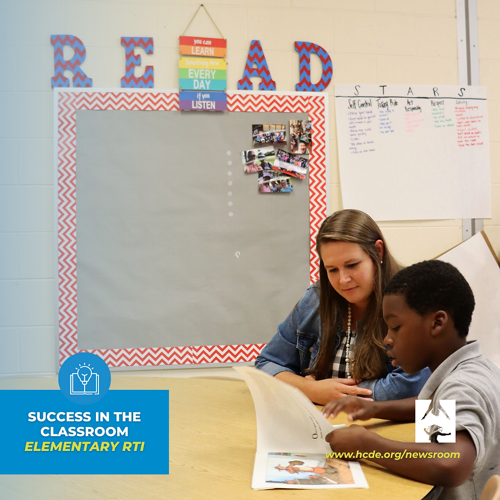 Student and teacher reading a book.