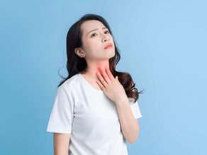 Young woman experiencing an itchy throat and seasonal allergy symptoms in Volusia County, seeking relief at Volusia Medical Center.