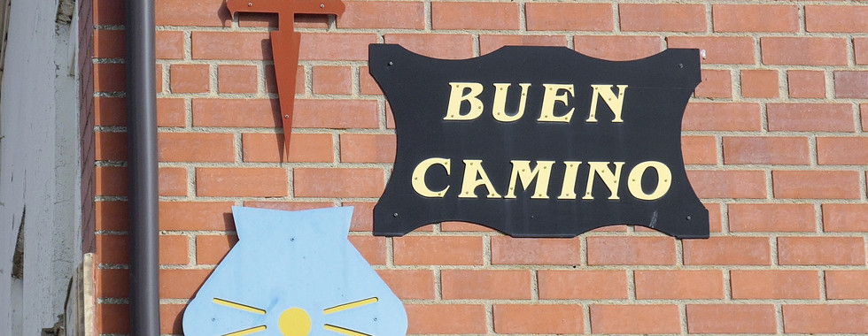 8) Here are markers on the side of a building telling pilgrims they are on the Camino toward Santiago.