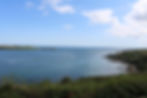 This picture was taken from Camden Fort Meagher looking south-eastwards on Sunday 25 August 2019 towards the outer harbour! On the left is Roches Point lighthouse and on the right is Graball Bay which as the name suggests in “earlier” times is where ships were tricked into shoreline and the cargos of stricken ships were “grabbed” by locals. The distance across the harbour entrance here is about 1200m (3/4 mile) with strong currents.
For those of you with good eyesight there is a Green Buoy as a channel marker to the left of boats on right beyond Graball. Near this is where the Titanic was anchored on the final stop of its maiden voyage (11 Apr 1912). Passengers were transferred from Cobh (then Queenstown) to the liner on board the tenders PS Ireland and PS America. On a happier note, in July 2020, the RCYC (Royal Cork Yacht Club) based in Crosshaven, the world’s oldest yacht club celebrating 300 years, will have yachts from across the globe racing in the inner and outer harbour.