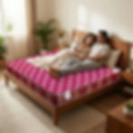 Couple relaxing on a patterned mattress with a comforter in a bedroom setting.
